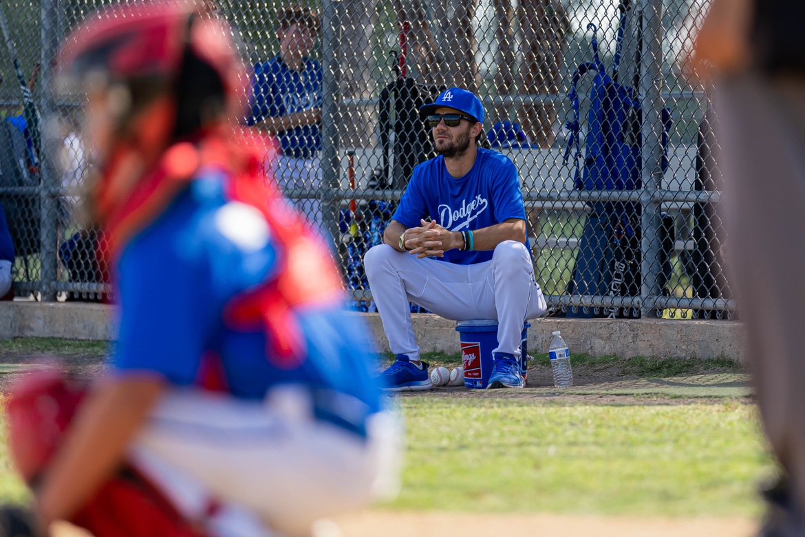 Matt Young watching the game from the dugout as his catcher plays