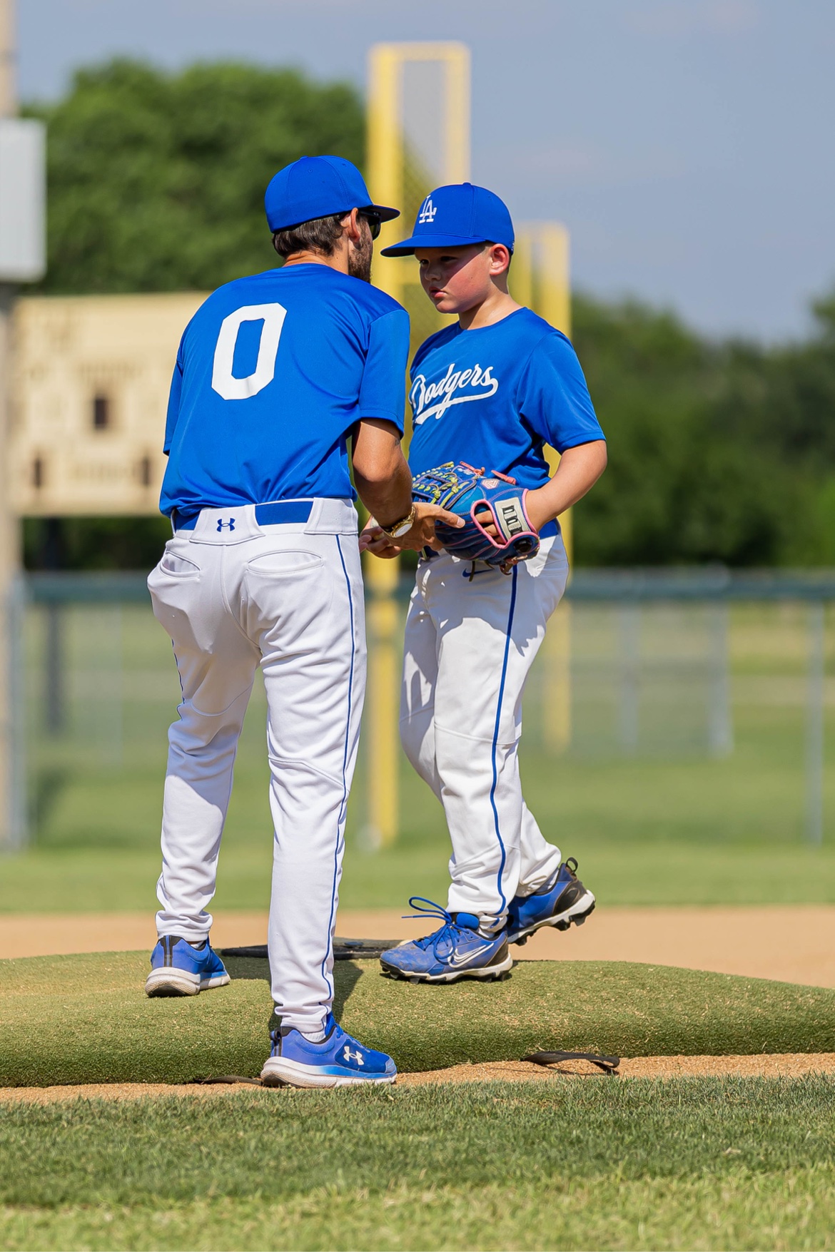 Matt Young talking one-on-one with a young pitcher on the mound