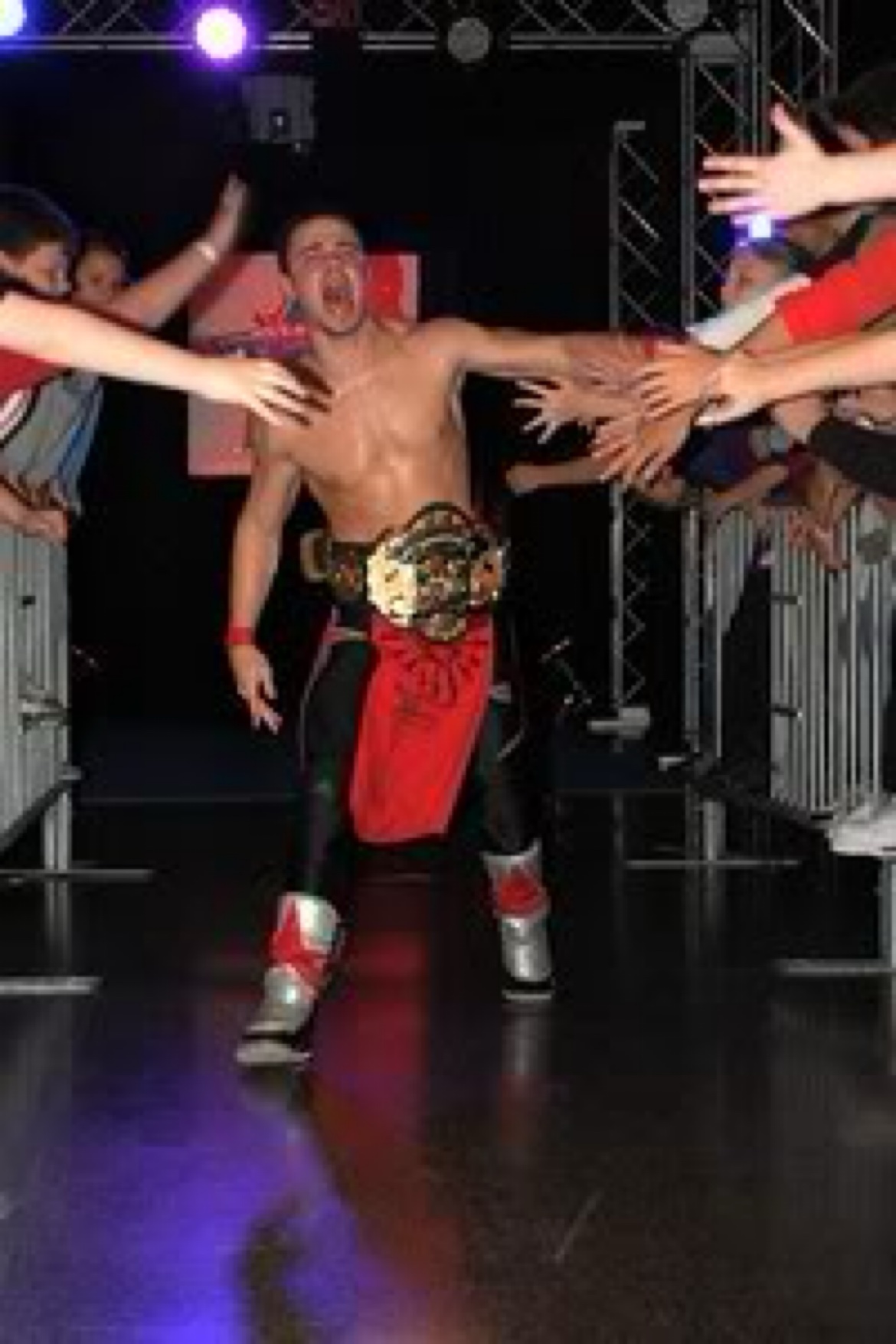 Matt Young in the ring with arms spread to the crowd